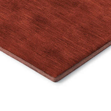 Close-up of the textured, red Dalyn Luxury Merry & Bright washable rug. Its edge is visible.