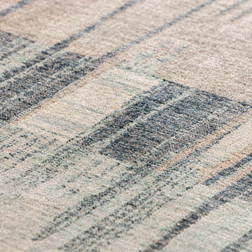 Close-up of the Dalyn Neola NA11 Navy Area Rug showing its texture, chestnut, light blue, navy, and taupe colors.