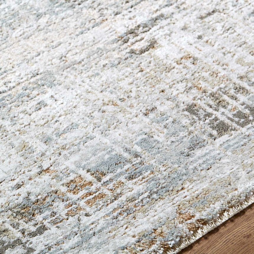 Close up of the Neron Blue Gray rug showing its thick, luxe texture and abstract charcoal, cream, and brown pattern. Texture