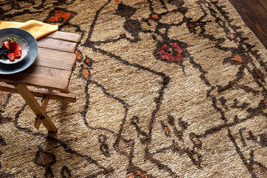 Close-up of the Neeses Premium Jute Rug showing beige, brown, and burnt orange tones with a bohemian-inspired pattern. Styleshot