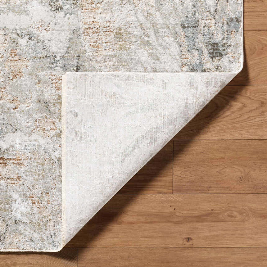 Close up of the Nurit Sage Thick Luxe Boutique Rug showing its charcoal, cream, and light brown Southwestern pattern and texture. Fold