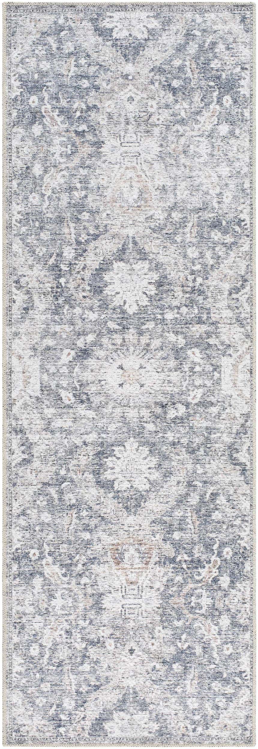 Close-up of the Arnaud Washable Area Rug. Beige and navy rug with a traditional, distressed floral pattern. Design-Runner-27710