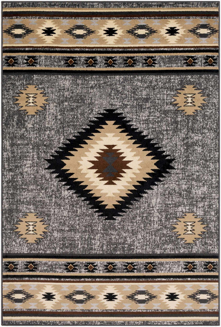 Close-up of the Buckhaven Area Rug. Southwestern design in black, charcoal, beige, and brown. Polypropylene, machine woven texture. Design-Rectangle