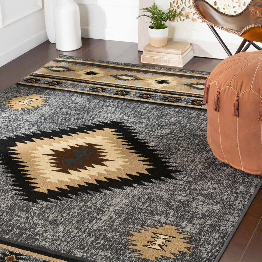 Living room scene with a brown Buckhaven Area Rug, beige sofa, and wooden furniture. Roomscene-Rectangle