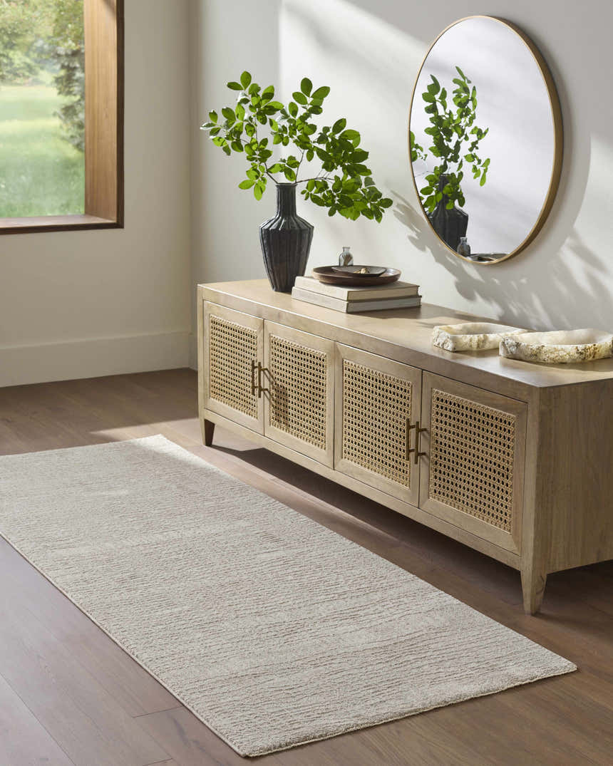 Entryway with wood floors, console table, and a cream Axelia Charcoal Area Rug runner. Roomscene-Runner