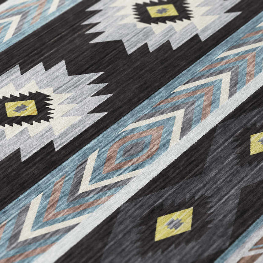 Close-up of the Dalyn Phoenix PH3 Black Washable Area Rug, featuring Southwestern design, black, blue, gold, and gray colors.