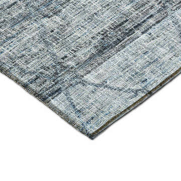 Close-up of the textured Dalyn Luxury Portico PO1 Blue Washable Area Rug. Denim, light blue, and taupe hues.