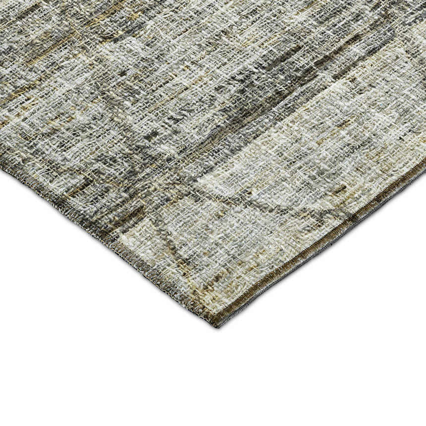 Close-up of the textured Dalyn Luxury Portico PO1 Pewter Washable Area Rug. Colors include gold, gray, peach, and taupe.