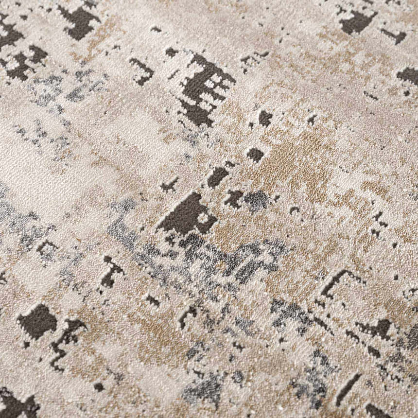 Close-up of the Pewamo Area Rug showing its abstract pattern in black, charcoal, beige, and tan. Texture