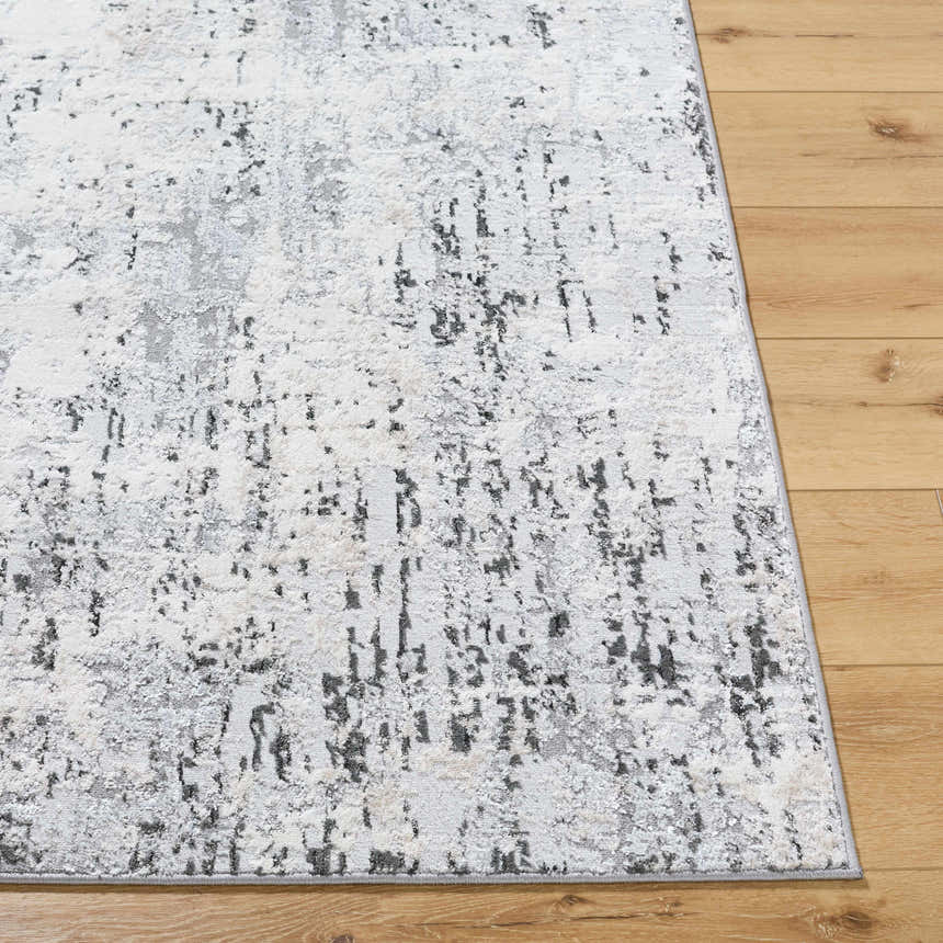 Close-up of the Avital Area Rug. Contemporary design with black, charcoal, gray, and white hues. Machine woven texture. Front