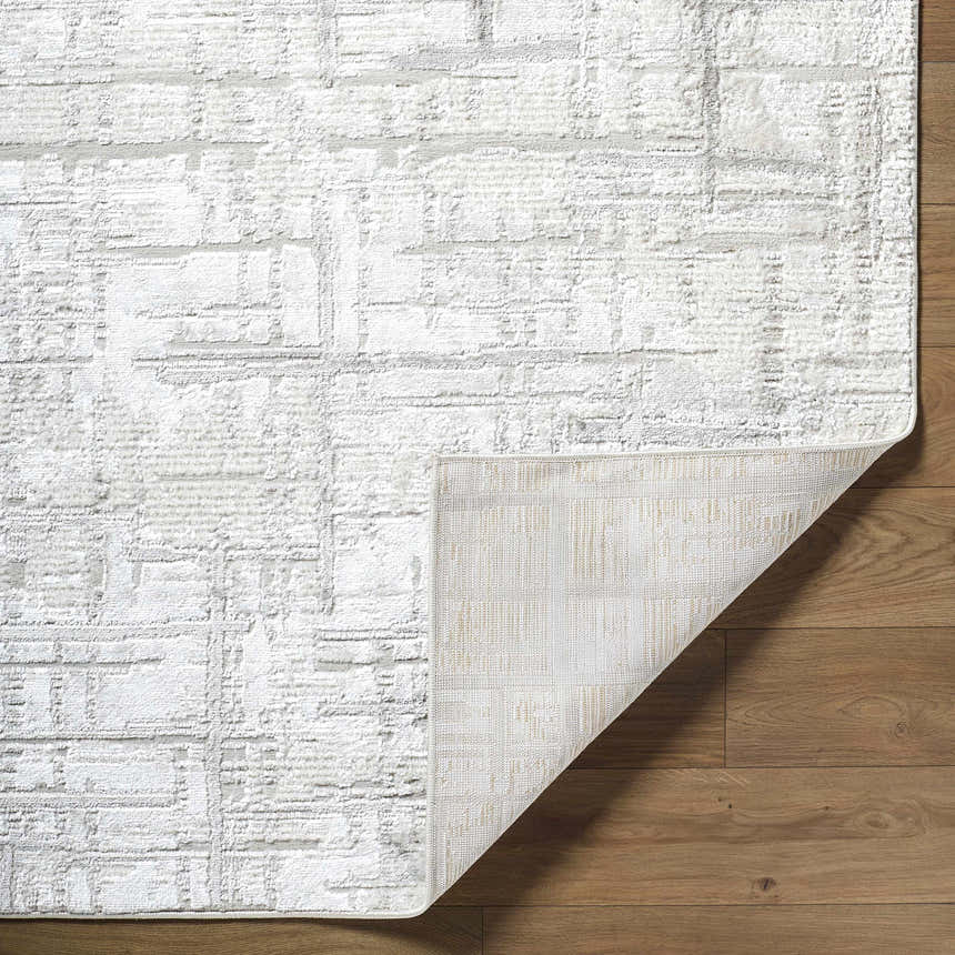 Close up of the cream and light gray Antony Area Rug showing the textured, contemporary design. Fold