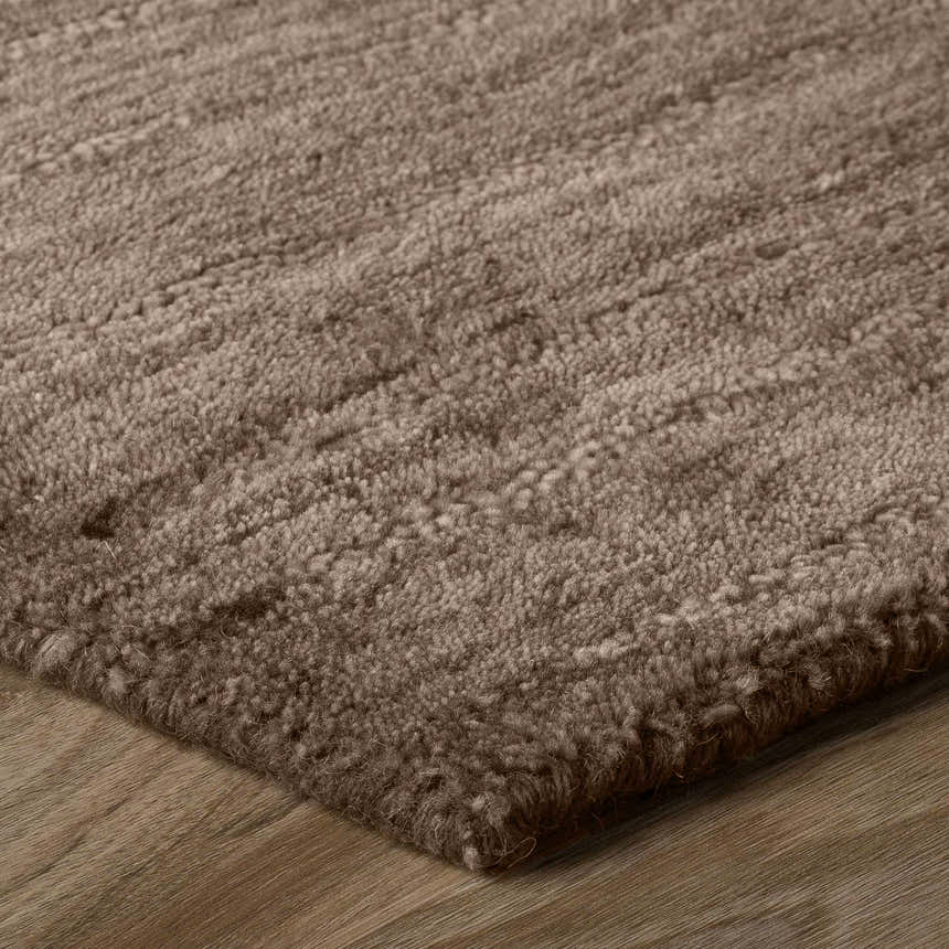Close-up of the hand-loomed Dalyn Rafia RF100 Chocolate Area Rug, a brown wool rug with a soft, textured pile.