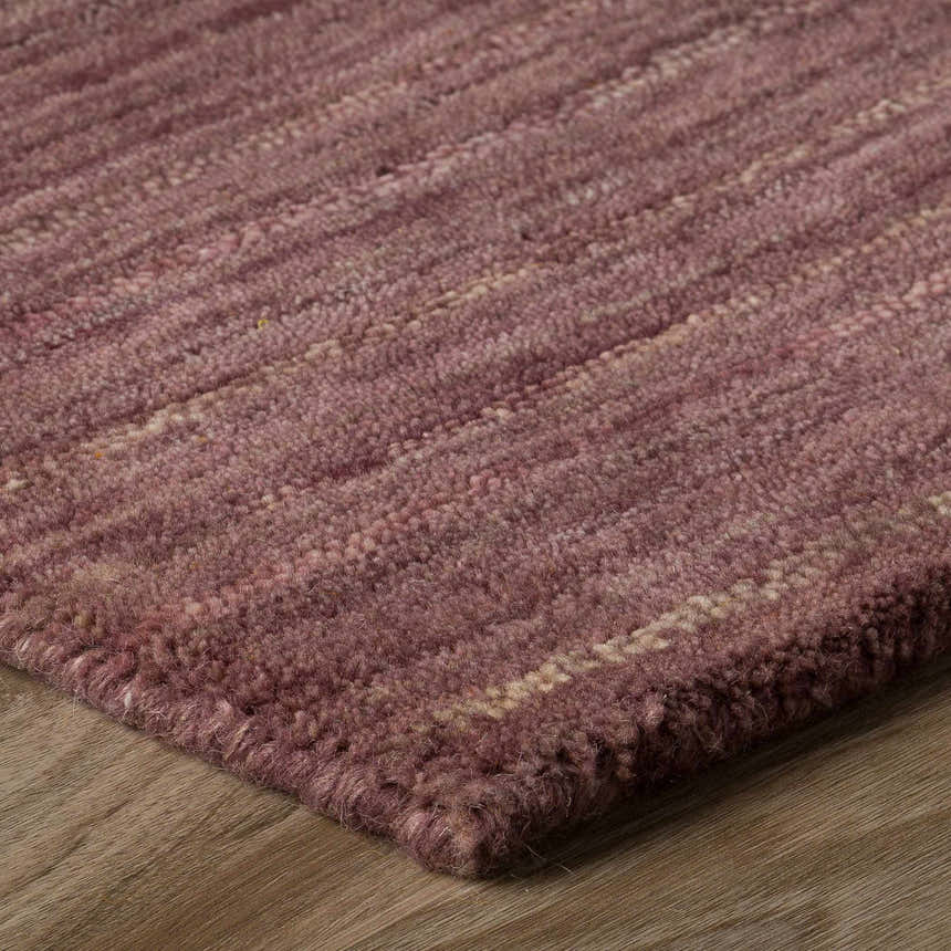 Close-up of the hand-loomed Dalyn Rafia RF100 Plum Area Rug. Shows the dark purple wool texture and subtle stripe pattern.
