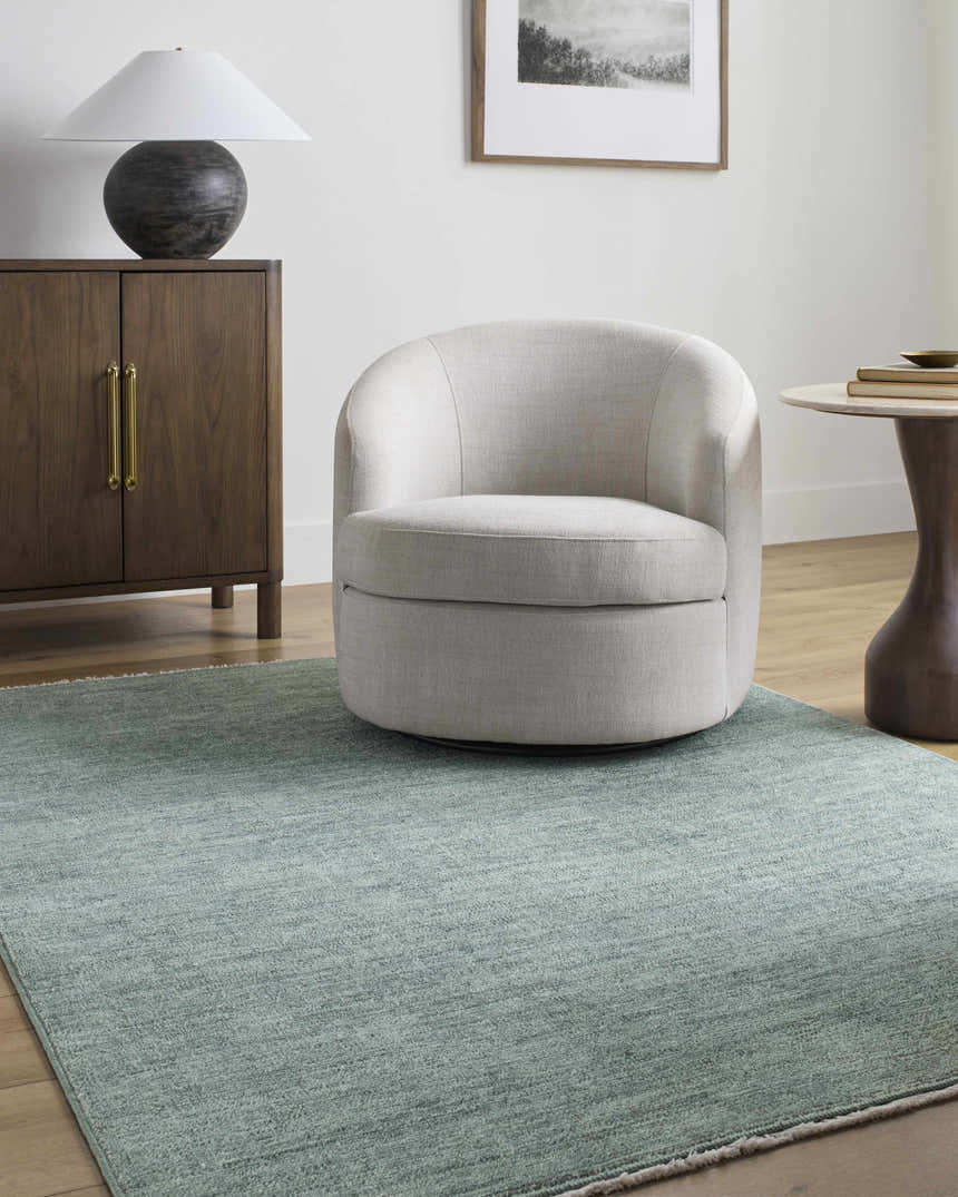 Living room scene with a Livabliss x Galey Alix Maria Elena II rug, cream chair, wood cabinet, and neutral decor. Roomscene-Rectangle