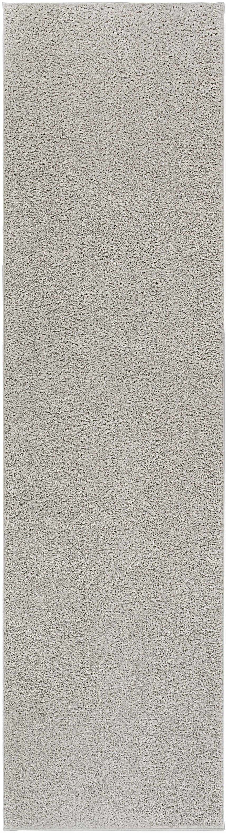 Close-up of the Judy Solid Gray Washable Shag Rug, showing its soft texture and light gray color. Design-Runner-2710