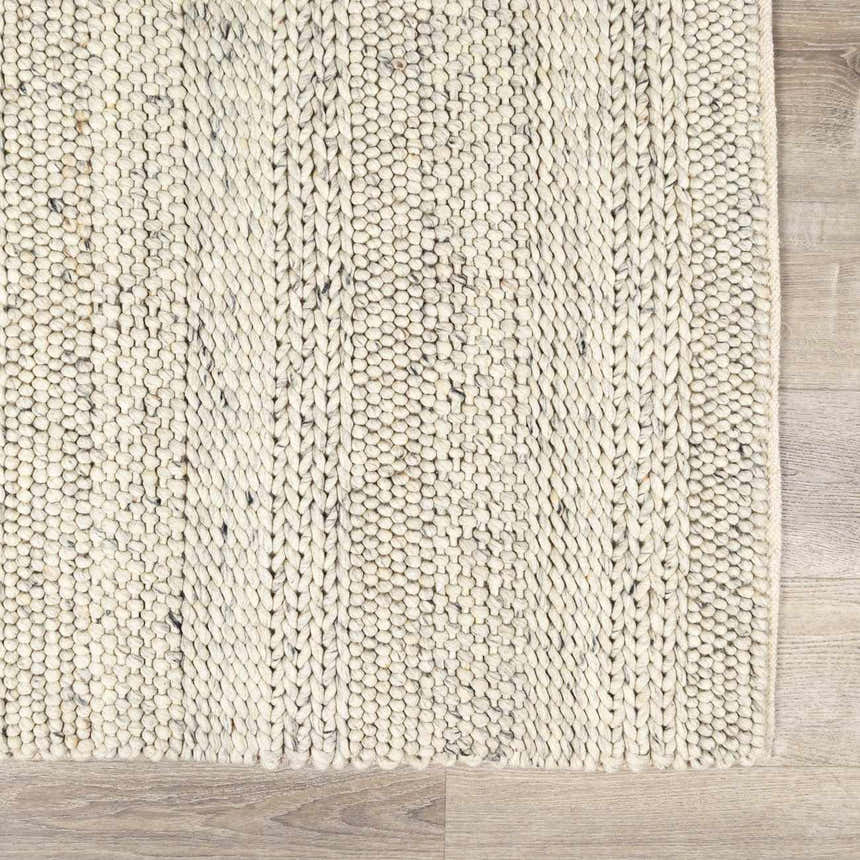 Close-up of the hand woven Salvo Luxury Wool Area Rug. Cream and ivory tones with a textured, braided design. Swatch