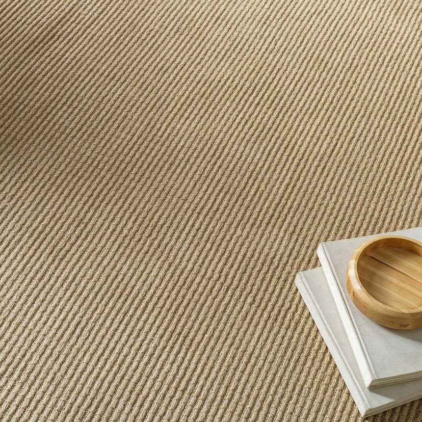 Close-up of Kimi Machine Woven Becki Owens x LIVABLISS rug showing light brown jute texture and diagonal weave pattern. Styleshot