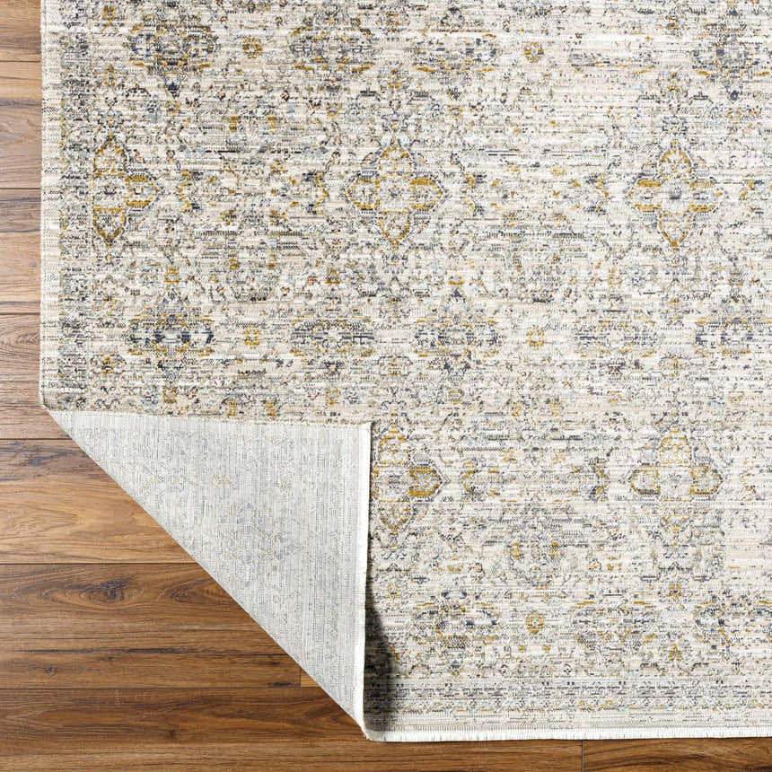 Close-up of Ren Outdoor Becki Owens x LIVABLISS BOMG-2306 rug showing its black, blue, brown, and taupe traditional pattern. Fold