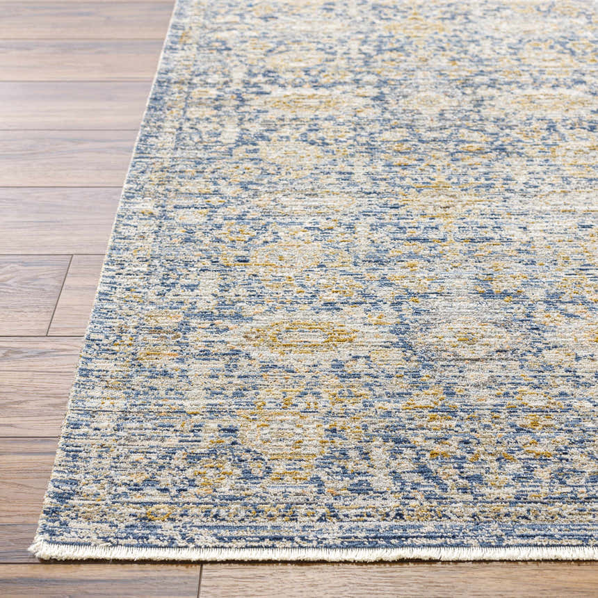 Close up of Ren Outdoor Becki Owens x LIVABLISS BOMG-2300 washable area rug. Navy, gray, and gold traditional pattern. Front