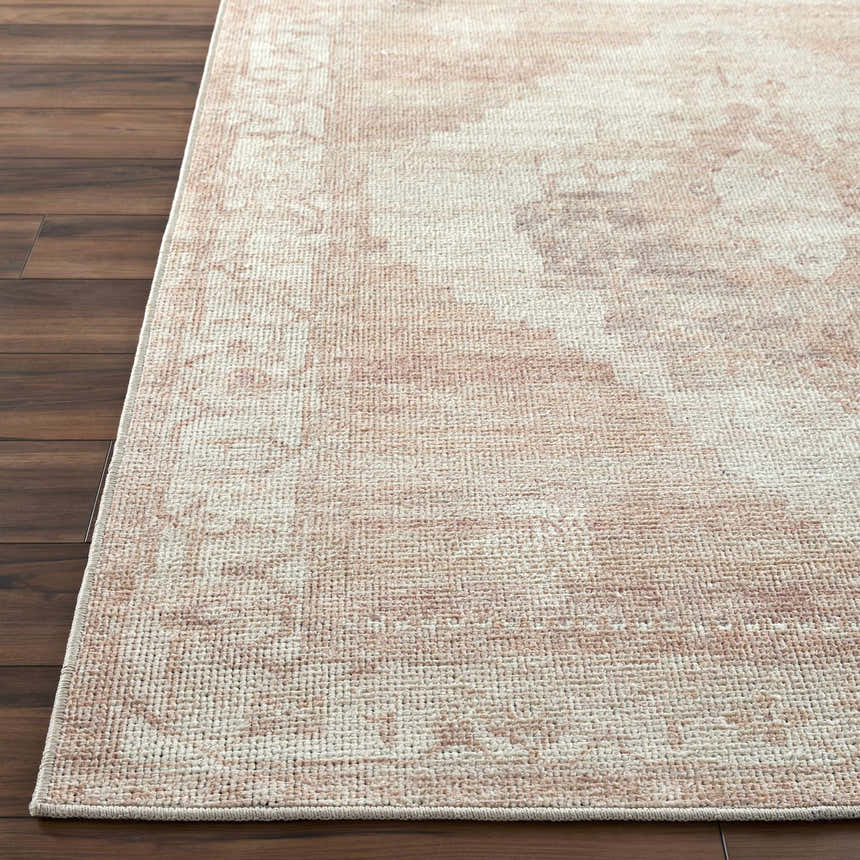 Close-up of the Luca Machine Woven Becki Owens x LIVABLISS rug. Traditional design in dark red, dusty pink, ivory, and tan. Front