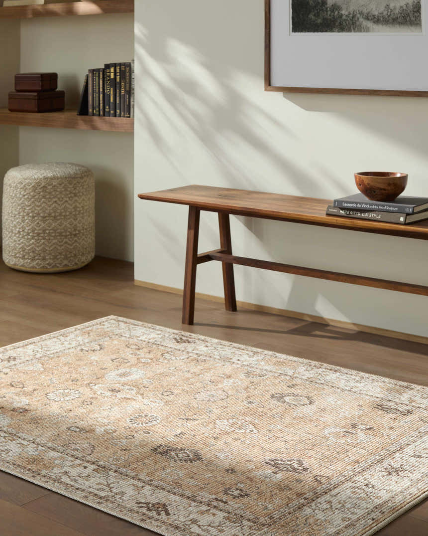 Living room scene with a Becki Owens x LIVABLISS Davina rug in cream and brown, styled with a wood bench and ottoman. Roomscene-Rectangle