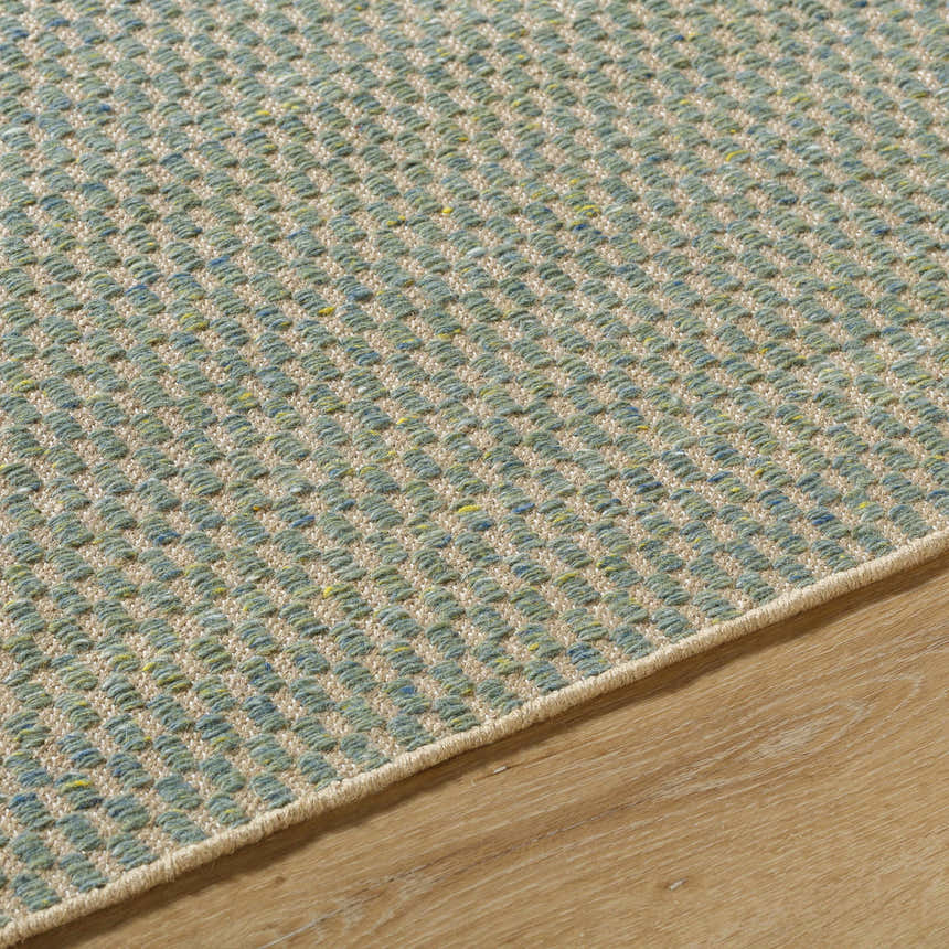 Close-up of the Verdel Sage rug showing its hand-woven texture, sage, tan, and teal colors, and farmhouse style. Texture