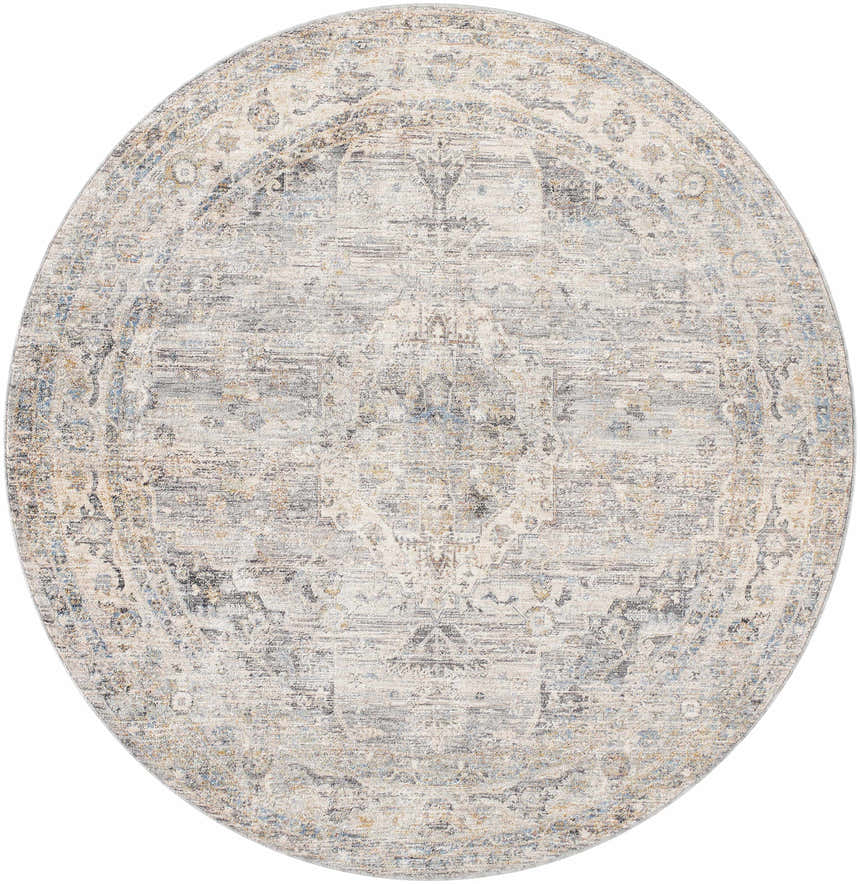 Close-up of round Addax Area Rug: neutral tones, traditional pattern in gray, brown, and blue. Machine woven polyester rug. Design-Round-67
