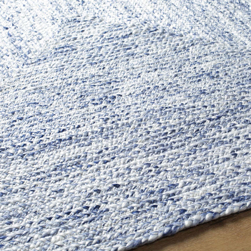 Close-up of the hand woven Kenyi Navy Area Rug. Recycled PET yarn in navy and white creates a textured, contemporary design. Texture
