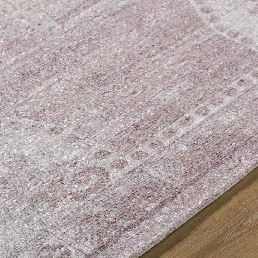 Close up of the hand tufted Alafin Area Rug. Colors include blush, cream, dusty rose, and mauve. Texture