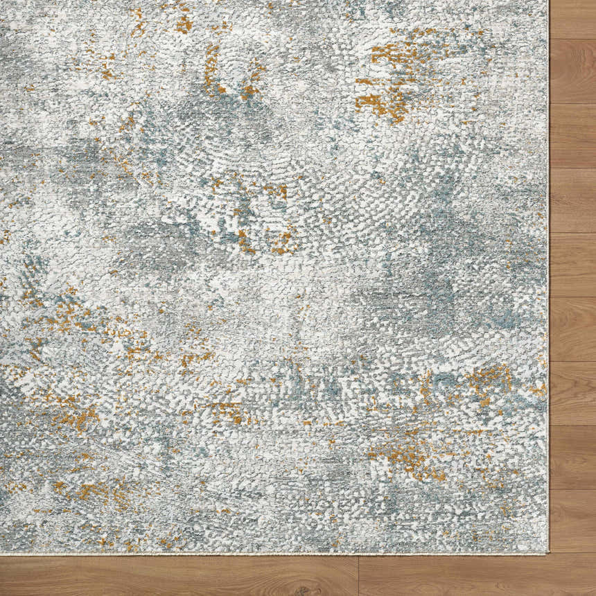 Close-up of the Fleur Textured Rug. Features a gray, white, and gold abstract pattern. Contemporary style rug. Corner