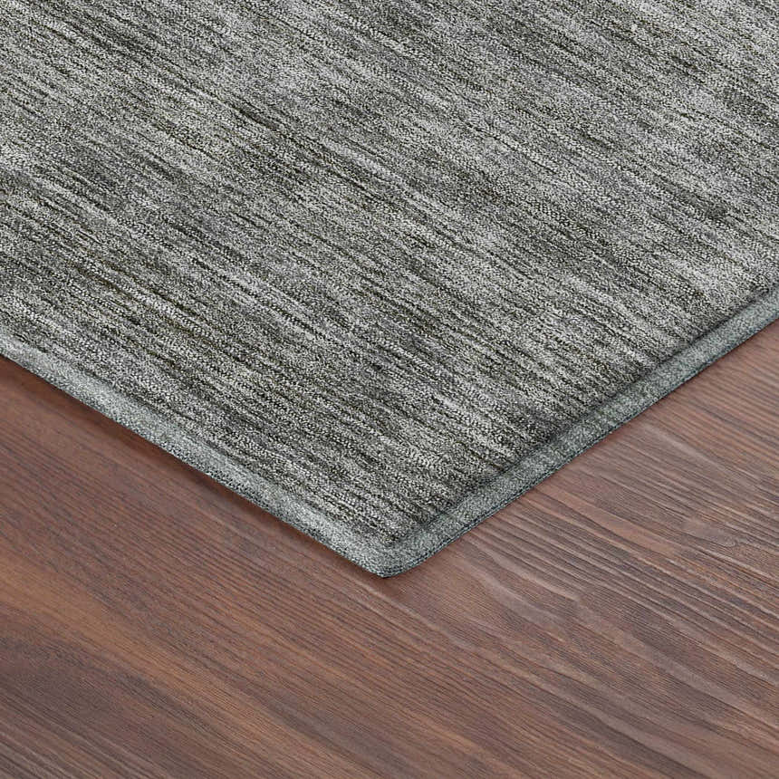 Close-up of the Dalyn Luxury Soft Essentials Gray Washable Area Rug showing texture and color on wood flooring.
