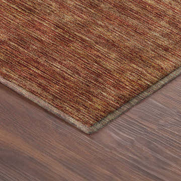 Close-up of the Dalyn Luxury Soft Essentials SE1 Paprika rug, showing texture and color variation on wood floor.