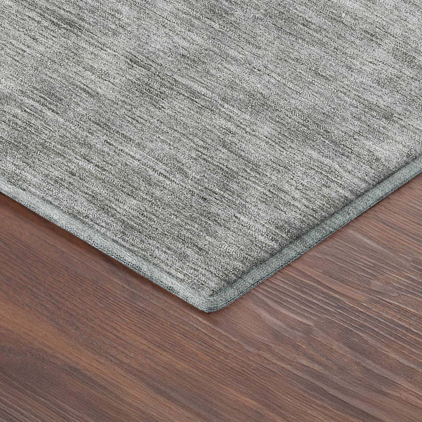 Close-up of Dalyn Luxury Soft Essentials Silver Washable Area Rug on a wood floor; shows texture and color.