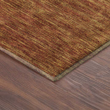 Close-up of the Dalyn Luxury Soft Essentials SE1 Terracotta Washable Area Rug showing burnt orange hues and textured design.