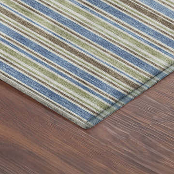 Close up of Dalyn Luxury Soft Essentials SE2 Blue Washable Area Rug with blue, green, and brown stripes on wood floor.