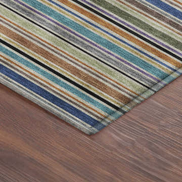 Close-up of Dalyn Luxury Soft Essentials Jewel Washable Area Rug with colorful stripes on a wood floor.