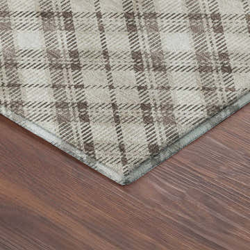 Close-up of Dalyn Luxury Indoor/Outdoor Soft Essentials SE3 Beige Washable Area Rug with a plaid pattern on a wood floor.