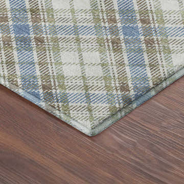 Close-up of Dalyn Luxury Soft Essentials Blue Washable Area Rug. Plaid pattern in light blue, green, brown, and cream.