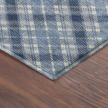 Close up of the Dalyn Luxury Soft Essentials Denim Washable Area Rug showing blue and gray plaid pattern.