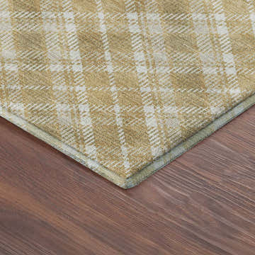 Close-up of the Dalyn Luxury Soft Essentials SE3 Gold Washable Area Rug showing its gold and white plaid pattern and texture.