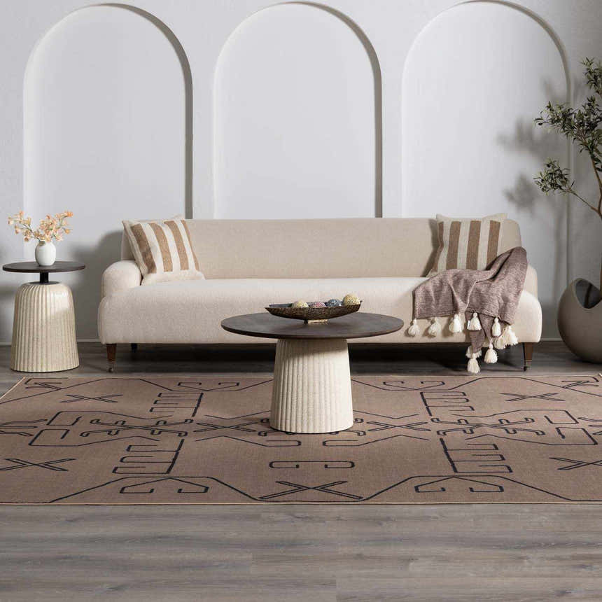 Living room scene with a camel Hamid Washable Jutely Rug, beige sofa, and round coffee table. Farmhouse style. Roomscene-Rectangle