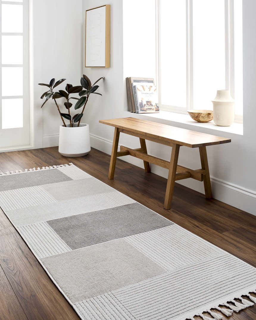 Entryway with Abia Gray Area Rug runner, wood bench, and plant. Neutral tones create a Scandinavian feel. Roomscene-Runner