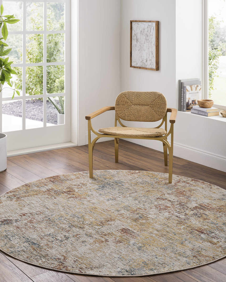 Bright room with round Chas Tan rug, wood floors, and a woven chair. Roomscene-Round