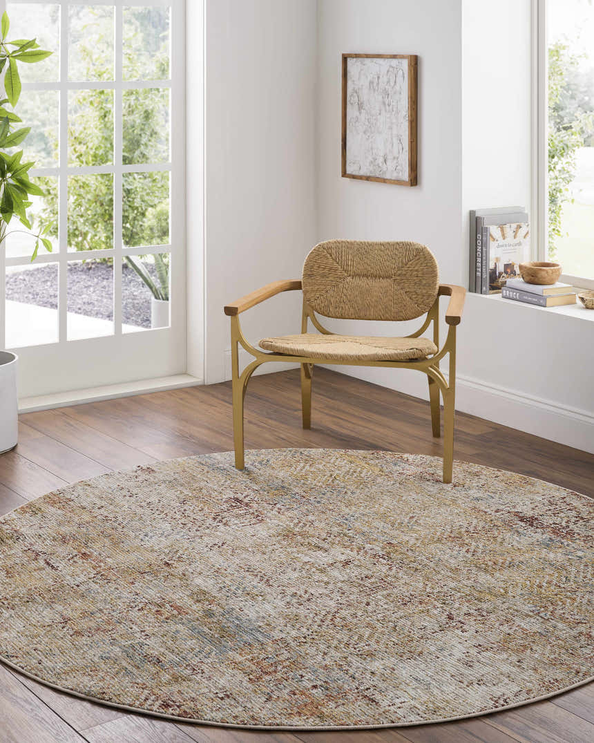 Light-filled room with round Sava Rust rug, woven chair, wood floors, and white walls. A cozy, contemporary scene. Roomscene-Round