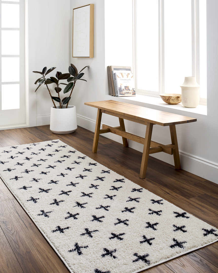 Entryway with Bede Washable Area Rug in beige with charcoal geometric cross pattern. Farmhouse style with wood bench and plant. Roomscene-Runner