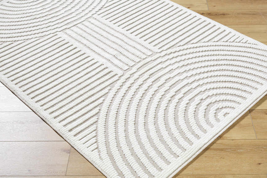 Close-up of the Deron Ivory 3D Rainbow Washable Rug, featuring a geometric pattern of raised lines and curves. Corner