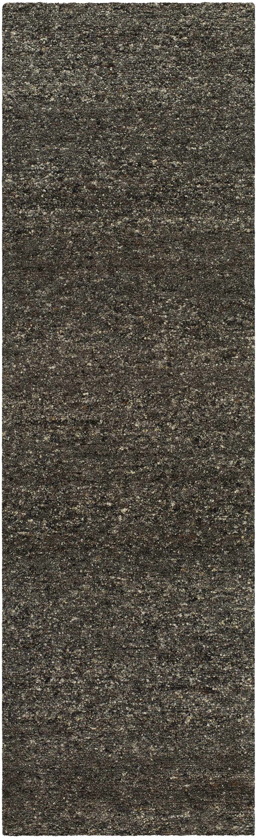 Close-up of the Sevan Black Wool Area Rug. Features a textured, hand-tufted design in jet black, medium gray, and taupe. Design-Runner-310