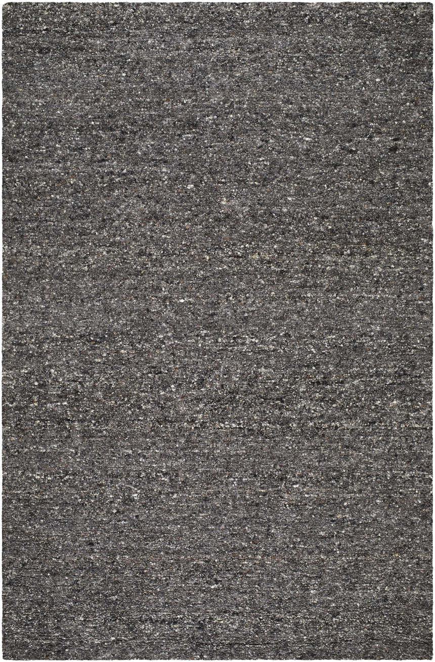 Close-up of the Sevan Black Wool Area Rug, a hand-tufted rug with a textured mix of jet black, medium gray, and taupe fibers. Design-Rectangle-576