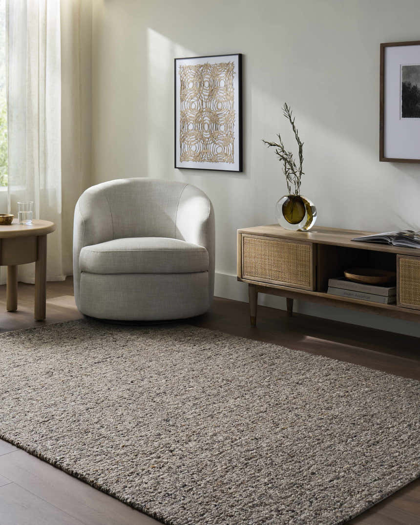 Living room scene with a Sevan Taupe Wool Area Rug, gray armchair, and wood media cabinet. Neutral, modern farmhouse style. Roomscene-Rectangle