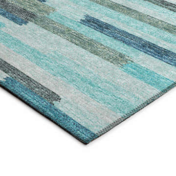 Close-up of Dalyn Sedona SN8 Poolside rug. Features a linear pattern in poolside blue, teal, and taupe hues. Machine-made texture.